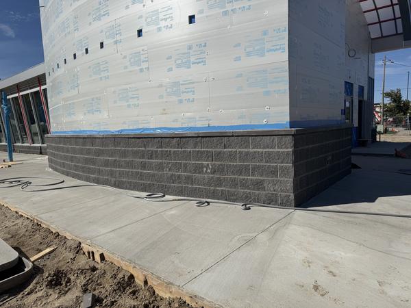 Split-face block base with cap, curved wall