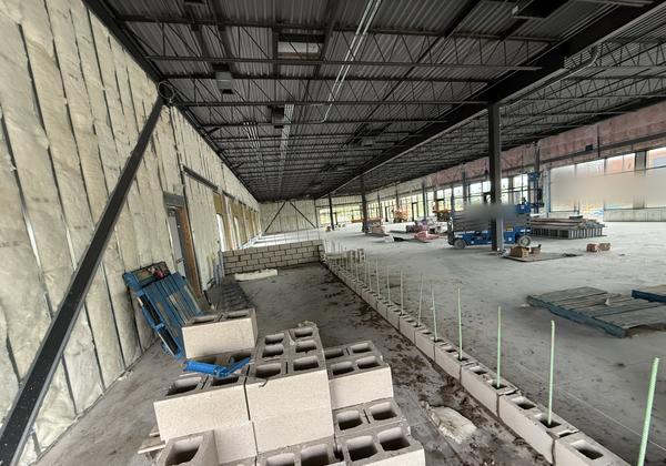 Block wall with rebar beside insulated steel stud walls, commercial