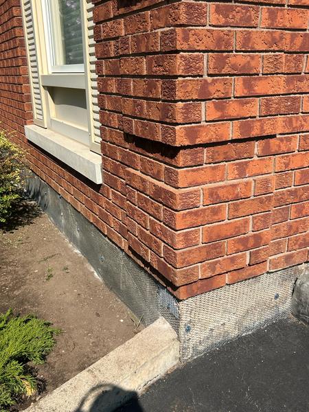 Metal lath on foundation below brick