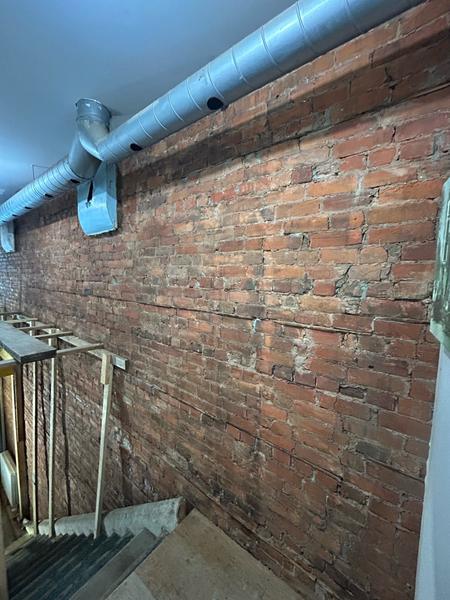 Interior brick wall along a stairwell