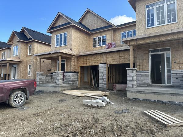 Stone porch piers and stone base, new homes