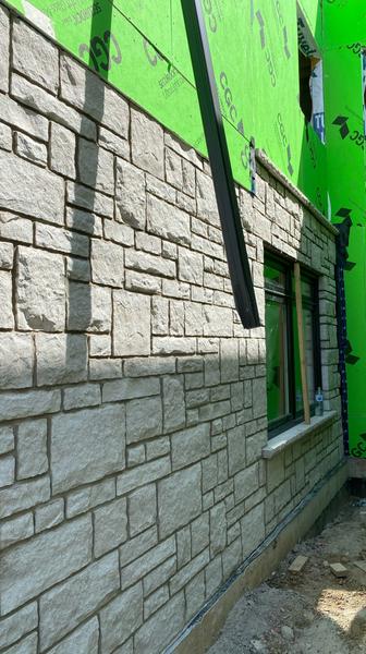Stone veneer beside exterior sheathing